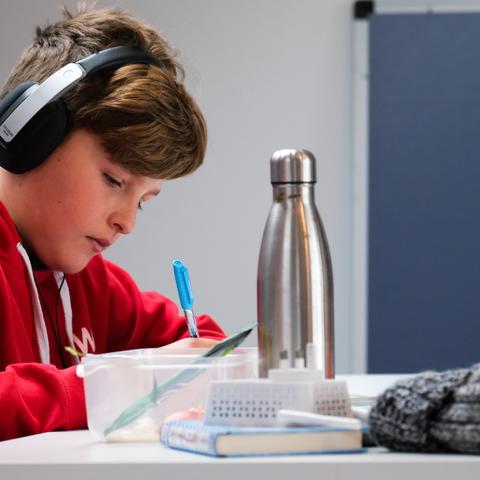 a student with headphones studying